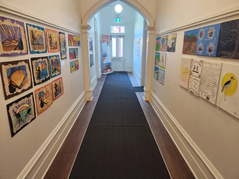 passageway view with arch on roof, carpet on floor and artwork on walls