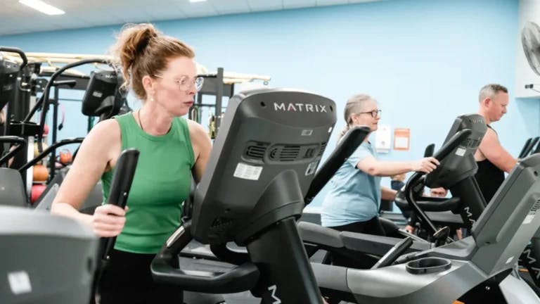 Gym attendees on walkers and treadmills