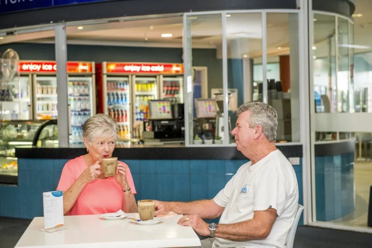 Two seniors having a chat over coffee