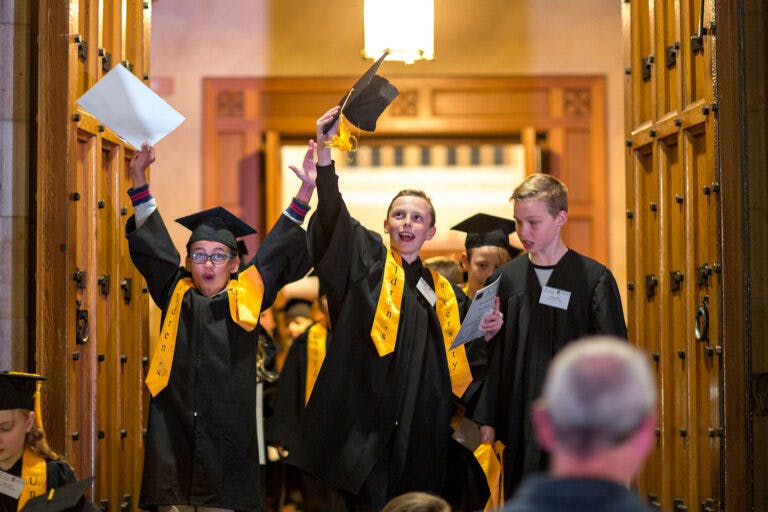 a group of kids wearing graduation gowns and caps