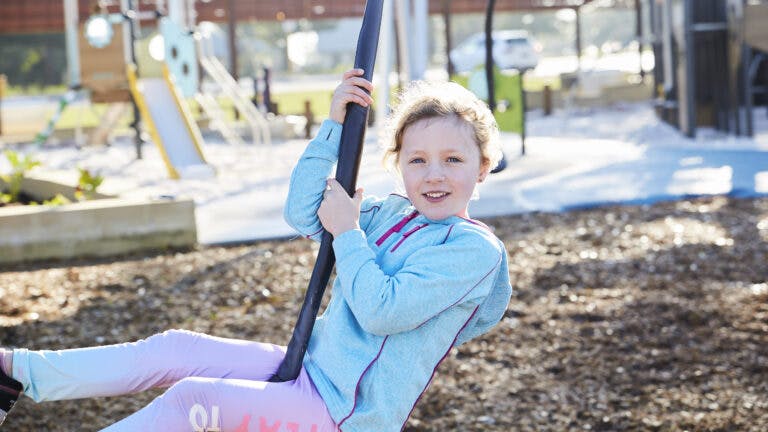 Young girl on a swing at Sykes Playground